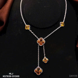 Necklace with floral pendants on a black background