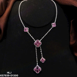 Necklace with pink floral pendants on a black background