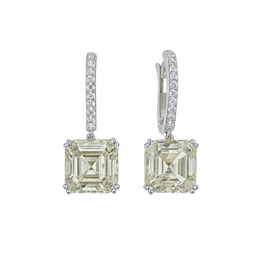 Pair of diamond earrings with green gemstones on a white background