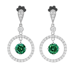 Pair of earrings with green gemstones and circular designs on a white background