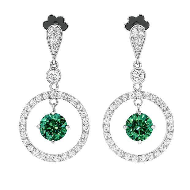 Pair of earrings with green gemstones and circular designs on a white background