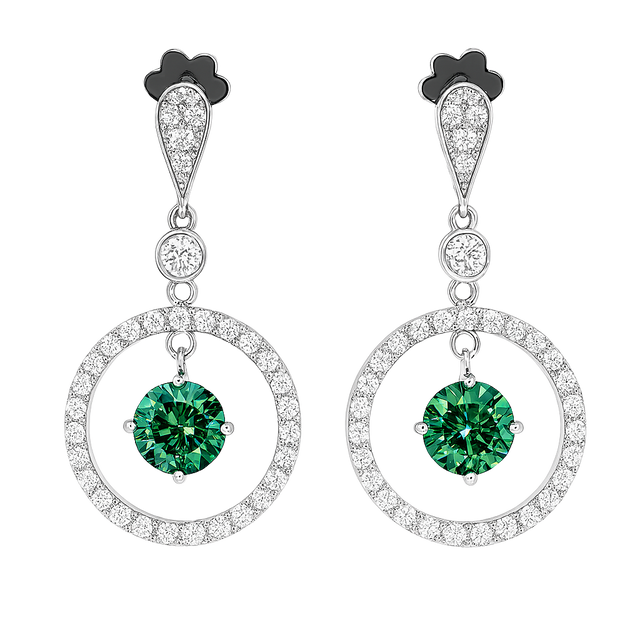 Pair of earrings with green gemstones and circular designs on a white background