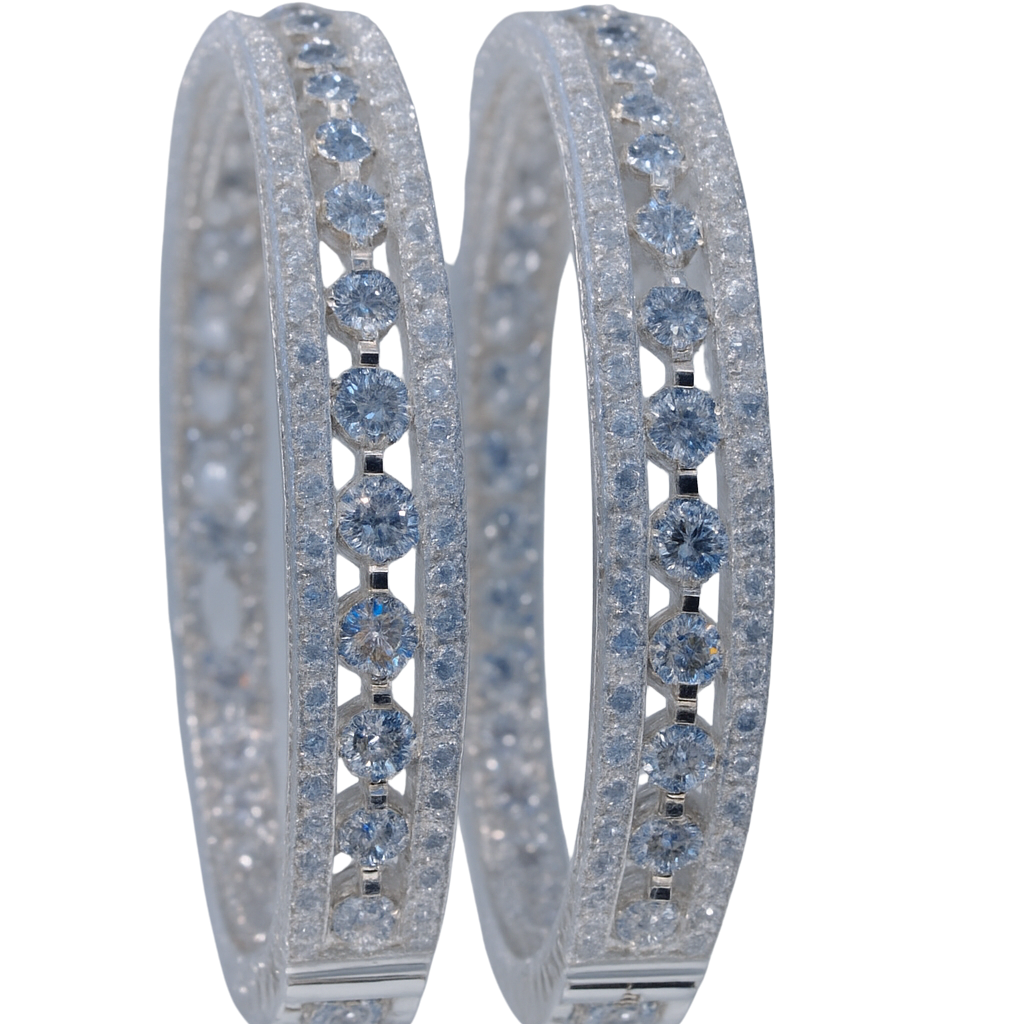 Pair of hoop earrings with blue gemstones on a white background