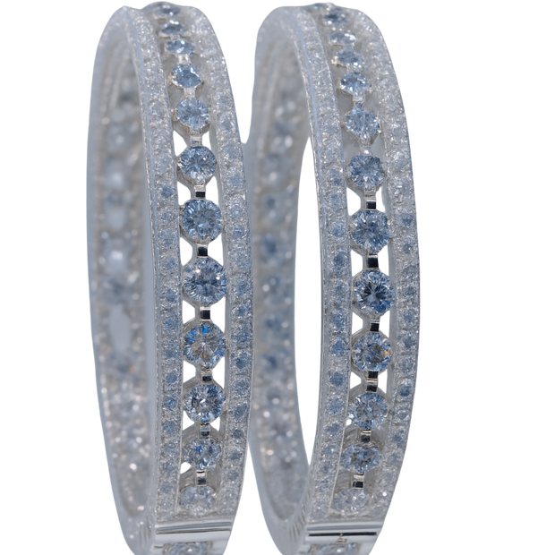 Pair of hoop earrings with blue gemstones on a white background