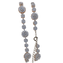 Pair of long, dangling earrings with diamond-like stones on a white background