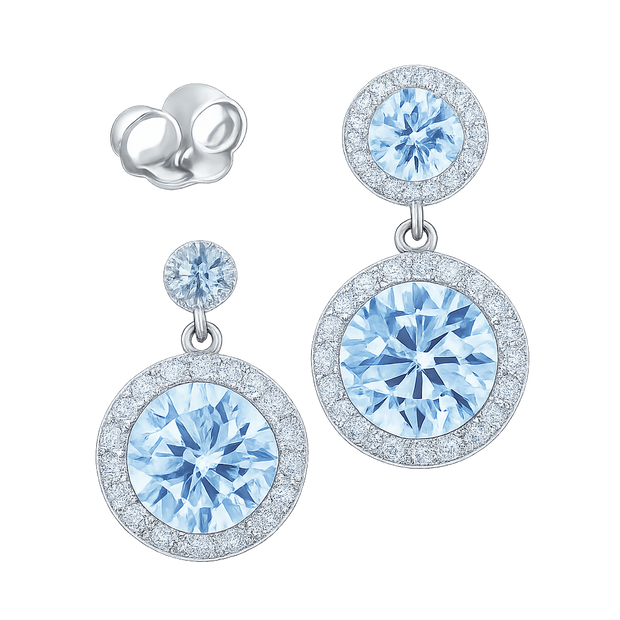 Pair of silver earrings with blue gemstones on a white background