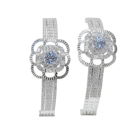 Pair of silver earrings with gemstones on a white background