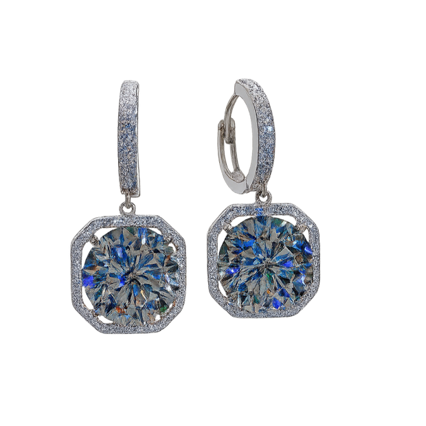 Pair of silver earrings with blue gemstones on a white background