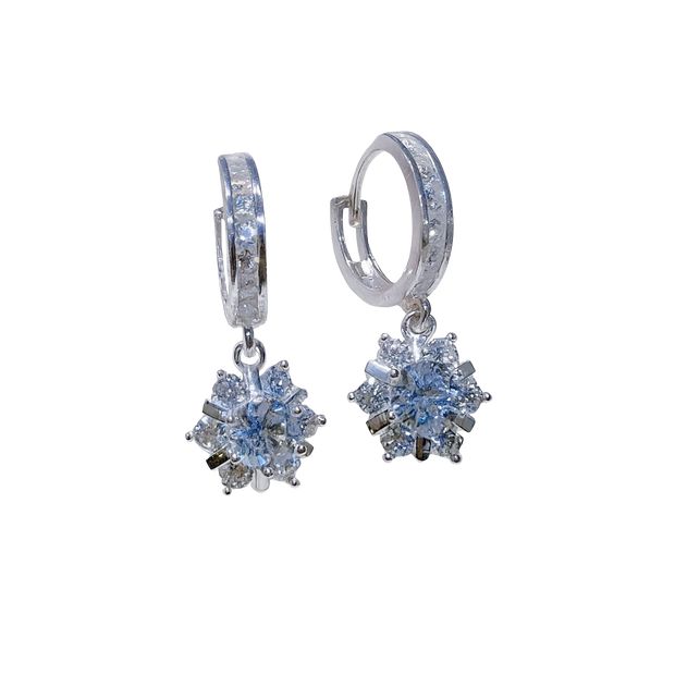 Pair of silver earrings with clear gemstones on a white background