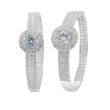 Pair of silver hoop earrings with clear gemstones on a white background