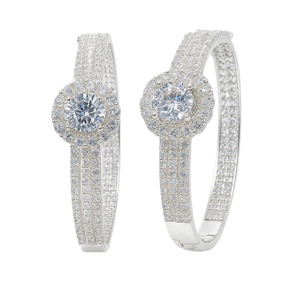 Pair of silver hoop earrings with clear gemstones on a white background