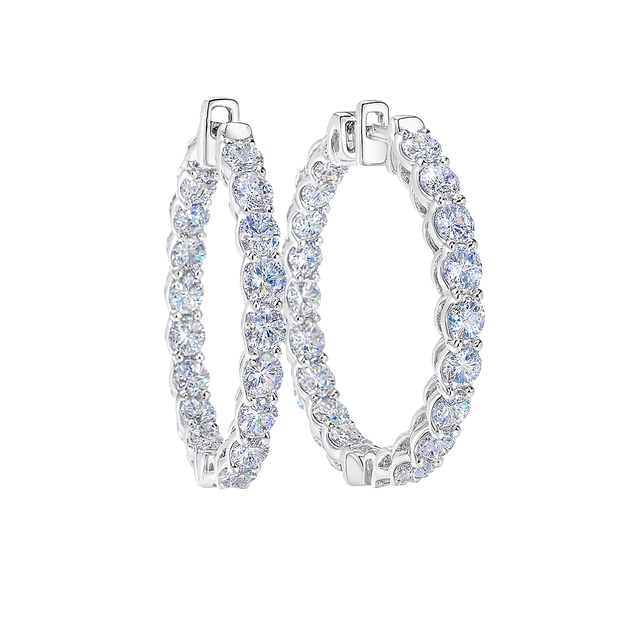 Pair of silver hoop earrings with clear gemstones on a white background