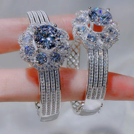 Pair of silver hoop earrings with gemstones on a blurred background