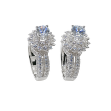 Pair of silver earrings with gemstones on a white background