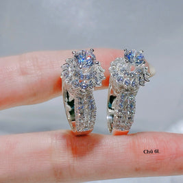Pair of silver rings with gemstones on a hand