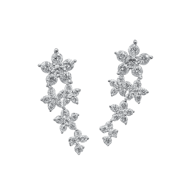 Pair of star-shaped earrings on a green background