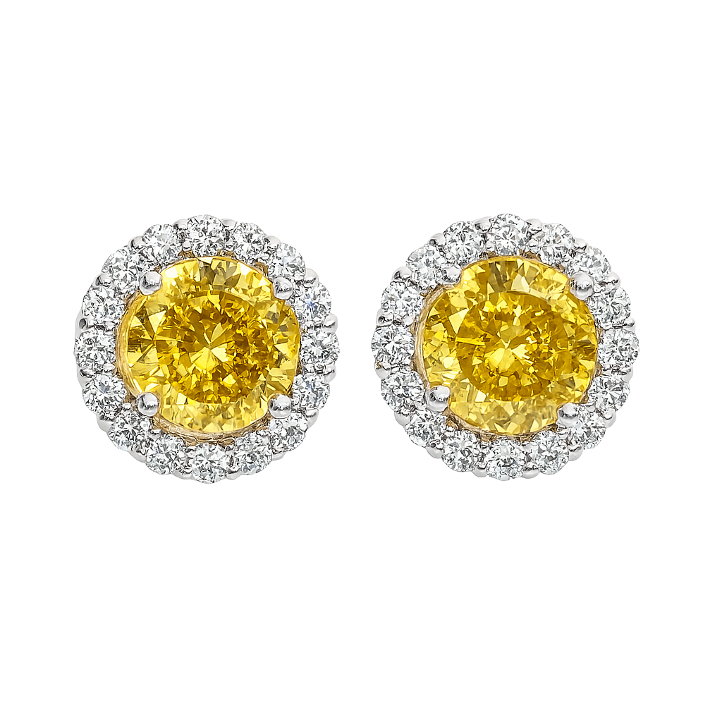 Pair of yellow gemstone earrings with silver halo on a white background