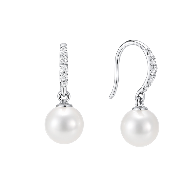 Pearl earrings with silver hooks and clear gemstones on a white background