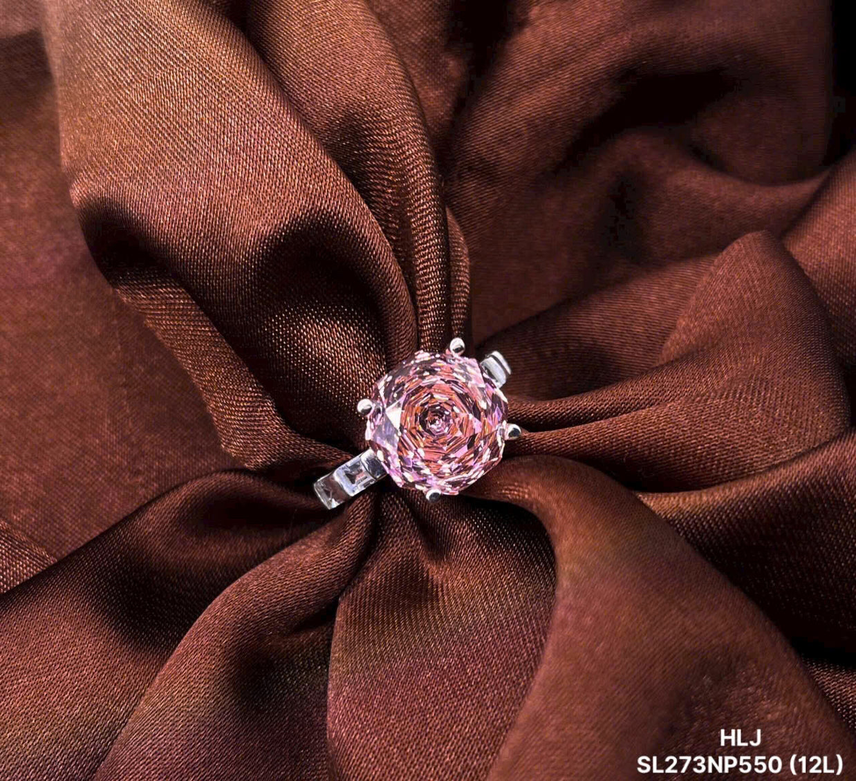 Pink rose-shaped jewelry on a brown fabric background
