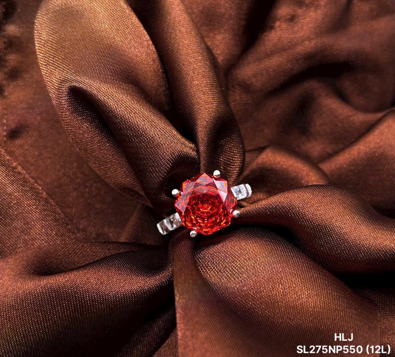 Red rose-shaped jewelry piece on brown fabric