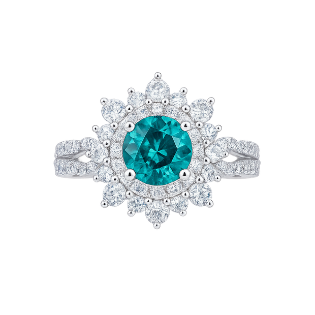 Ring with a central blue gemstone and diamond-studded halo on a white background
