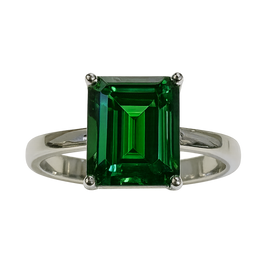 Ring with a green emerald-cut gemstone on a white background