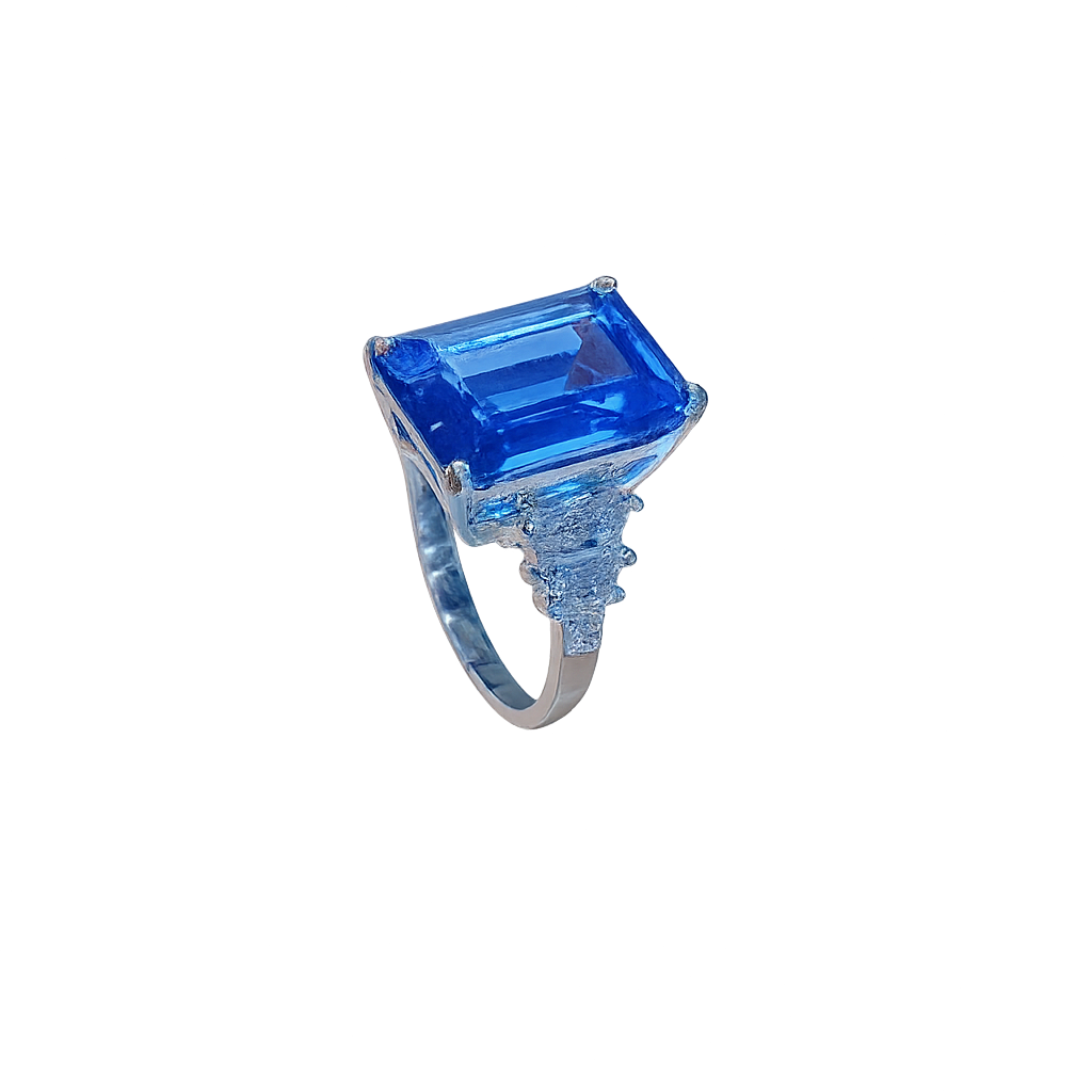 Ring with a large blue gemstone on a white background