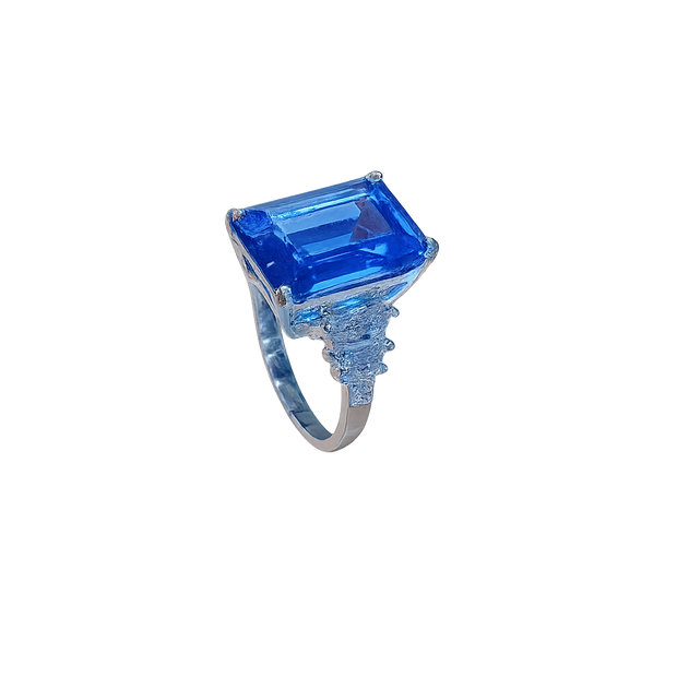 Ring with a large blue gemstone on a white background