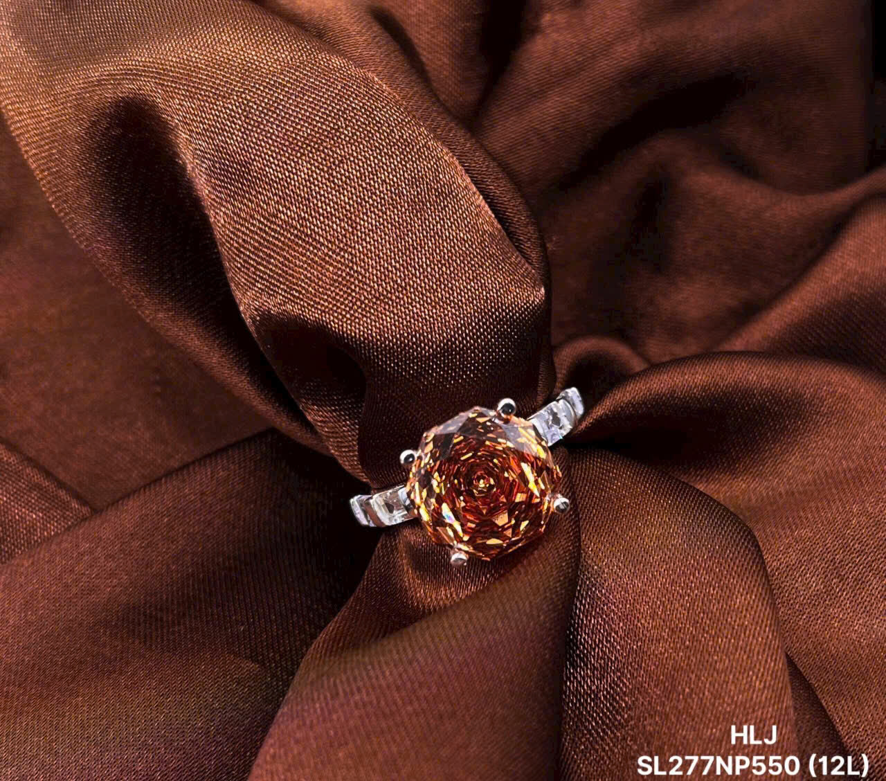 Ring with a large brown gemstone on brown fabric