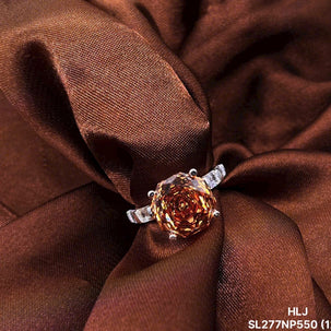 Ring with a large brown gemstone on brown fabric