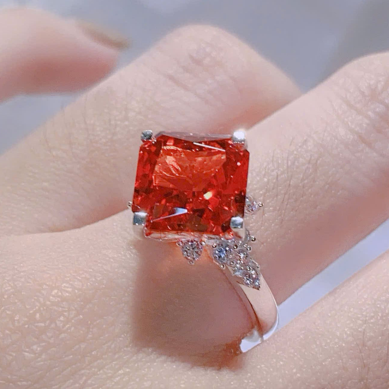 Ring with a large red gemstone on a finger