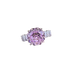 Ring with a pink gemstone and diamond accents on a white background