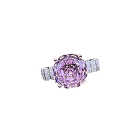Ring with a pink gemstone and diamond accents on a white background