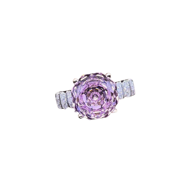 Ring with a pink gemstone and diamond accents on a white background