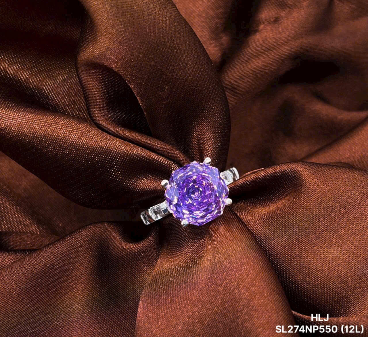 Ring with a purple gemstone on brown fabric