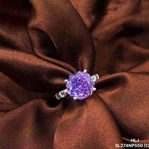 Ring with a purple gemstone on brown fabric