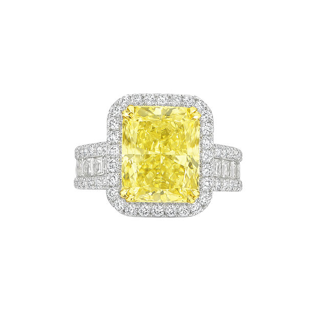 Ring with a yellow diamond and white gemstones on a white background