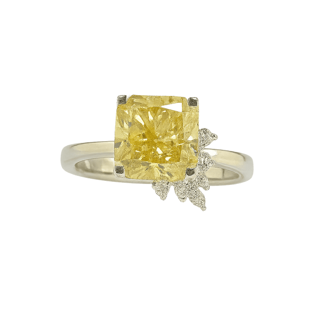 Ring with a yellow gemstone and small diamonds on a green background