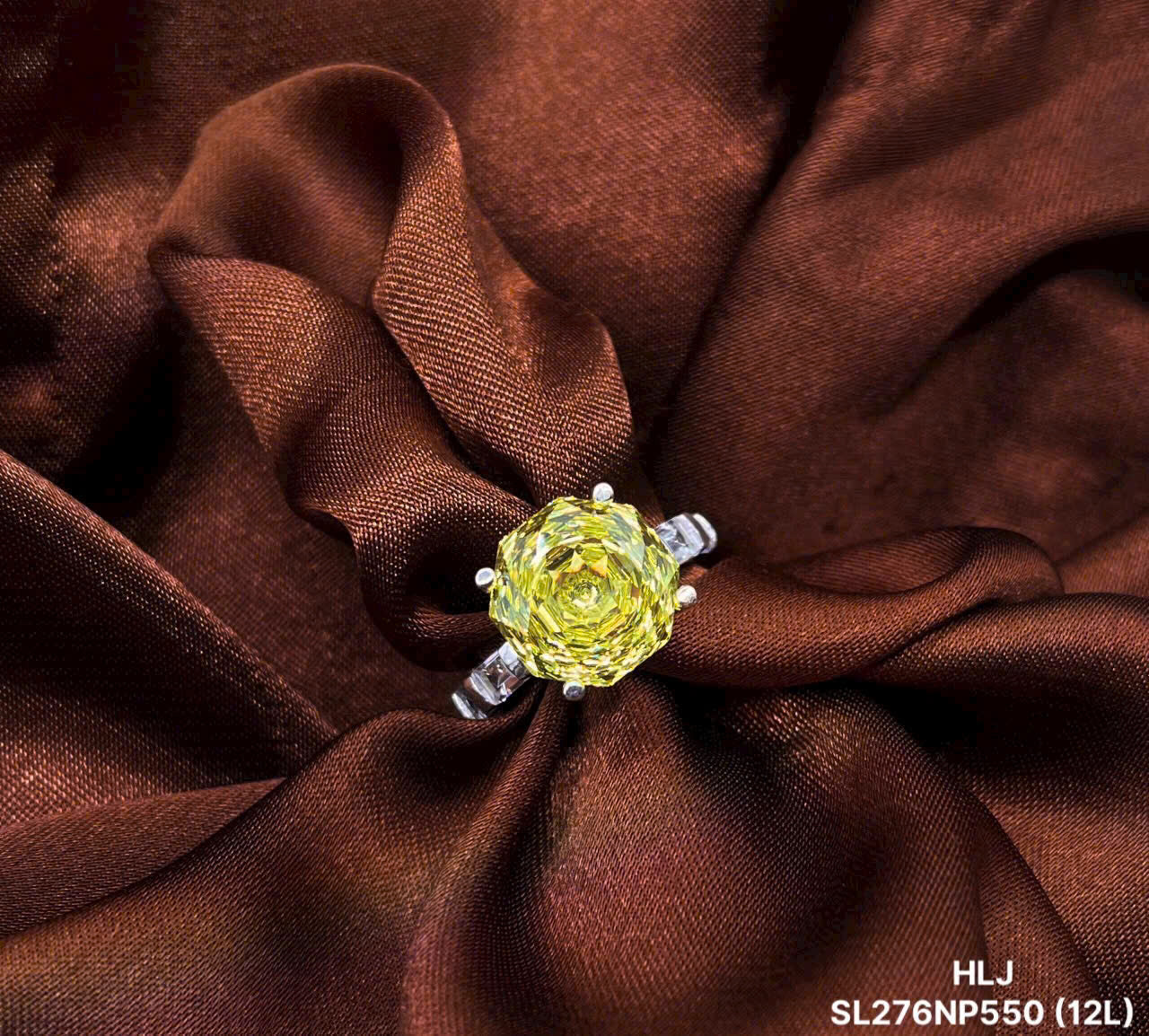 Ring with a yellow gemstone on brown fabric