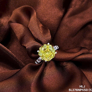 Ring with a yellow gemstone on brown fabric