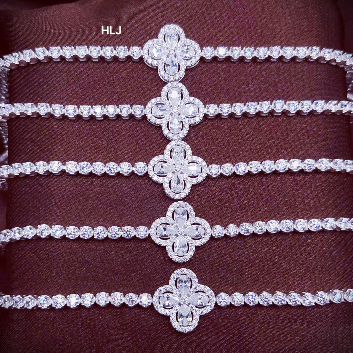 Set of diamond-studded bracelets on a dark background