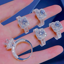 Set of diamond rings displayed on a hand with a blue background
