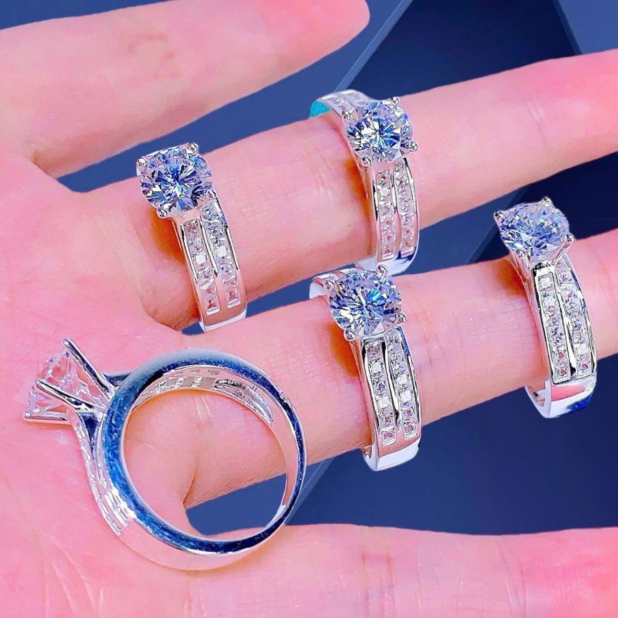 Set of diamond rings on a hand with a blue background