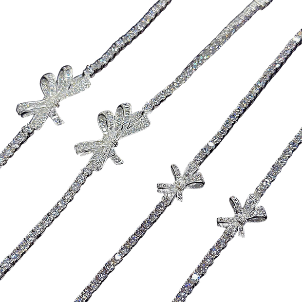 Set of silver hair sticks with decorative bows on a white background