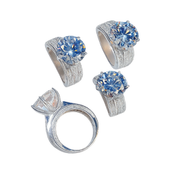 Set of silver rings with blue gemstones on a white background