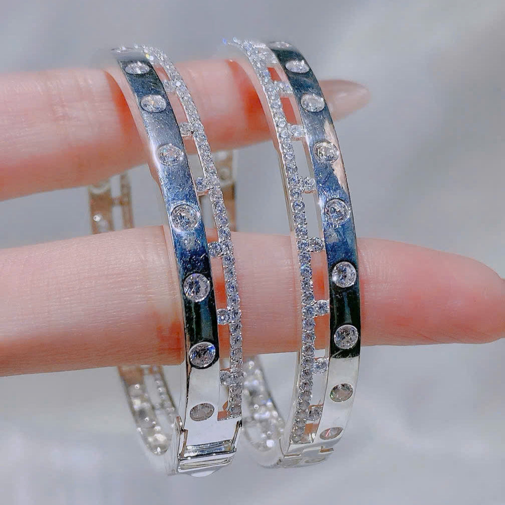 Silver bangles with gemstones on a blurred background