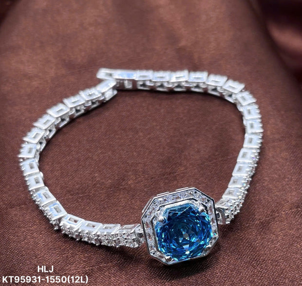 Silver bracelet with a blue gemstone on a brown background