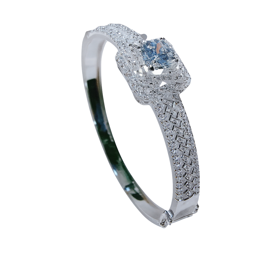 Silver bracelet with blue gemstones held by a hand against a blurred indoor background