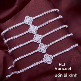 Silver bracelet with floral designs on a maroon fabric background, featuring the brand HLJ Vanceef.