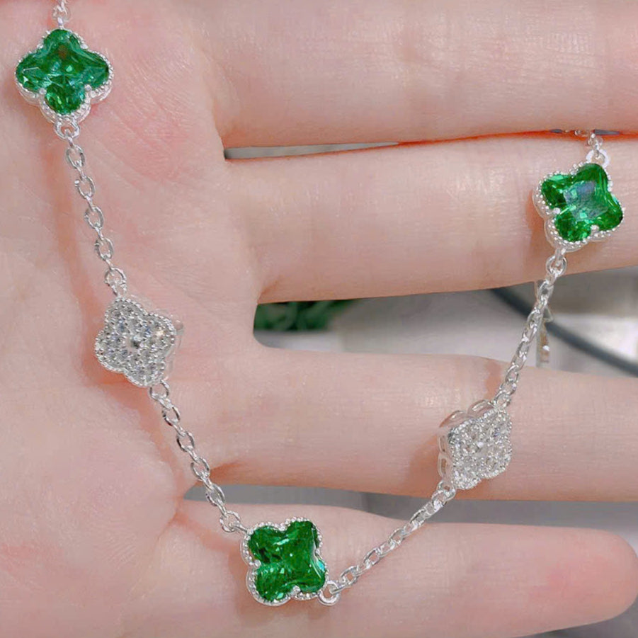 Silver bracelet with green gemstones on a hand